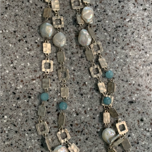 Long, silver tone geometric shape necklace with aqua accents. - Picture 3 of 3